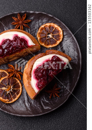 Cinnamon roll, a sweet bun with citrus, cherries, and chocolate, a Danish dessert with cream Cinnamon roll, a sweet bun with citrus, cherries, and chocolate, a Danish dessert with cream 133503162