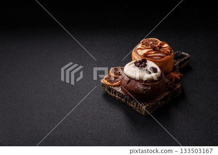 Cinnamon roll, a sweet bun with citrus, cherries, and chocolate, a Danish dessert with cream 133503167