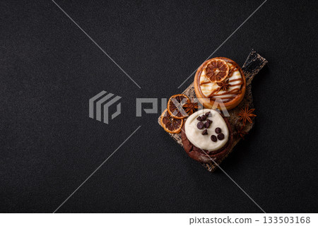 Cinnamon roll, a sweet bun with citrus, cherries, and chocolate, a Danish dessert with cream Cinnamon roll, a sweet bun with citrus, cherries, and chocolate, a Danish dessert with cream 133503168