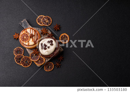 Cinnamon roll, a sweet bun with citrus, cherries, and chocolate, a Danish dessert with cream Cinnamon roll, a sweet bun with citrus, cherries, and chocolate, a Danish dessert with cream 133503180