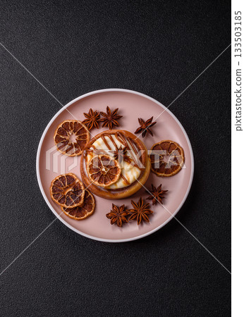 Cinnamon roll, a sweet bun with citrus, cherries, and chocolate, a Danish dessert with cream Cinnamon roll, a sweet bun with citrus, cherries, and chocolate, a Danish dessert with cream 133503185