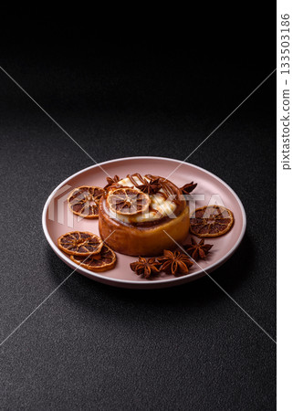 Cinnamon roll, a sweet bun with citrus, cherries, and chocolate, a Danish dessert with cream 133503186