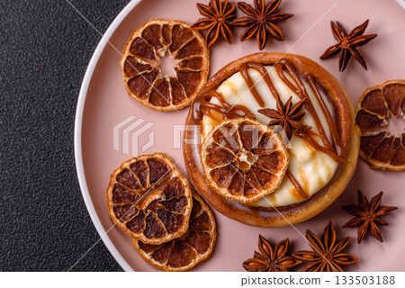 Cinnamon roll, a sweet bun with citrus, cherries, and chocolate, a Danish dessert with cream 133503188