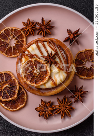 Cinnamon roll, a sweet bun with citrus, cherries, and chocolate, a Danish dessert with cream Cinnamon roll, a sweet bun with citrus, cherries, and chocolate, a Danish dessert with cream 133503189