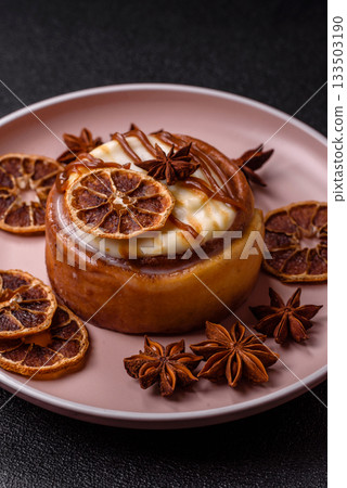 Cinnamon roll, a sweet bun with citrus, cherries, and chocolate, a Danish dessert with cream Cinnamon roll, a sweet bun with citrus, cherries, and chocolate, a Danish dessert with cream 133503190