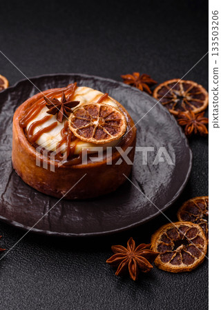 Cinnamon roll, a sweet bun with citrus, cherries, and chocolate, a Danish dessert with cream Cinnamon roll, a sweet bun with citrus, cherries, and chocolate, a Danish dessert with cream 133503206