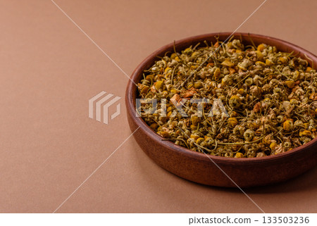 Dried chamomile flowers, herbal tea in a bowl for a hot morning drink. Dried chamomile Dried chamomile flowers, herbal tea in a bowl for a hot morning drink. Dried chamomile 133503236