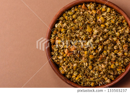 Dried chamomile flowers, herbal tea in a bowl for a hot morning drink. Dried chamomile 133503237