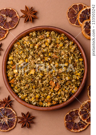 Dried chamomile flowers, herbal tea in a bowl for a hot morning drink. Dried chamomile Dried chamomile flowers, herbal tea in a bowl for a hot morning drink. Dried chamomile 133503242
