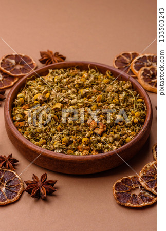 Dried chamomile flowers, herbal tea in a bowl for a hot morning drink. Dried chamomile 133503243