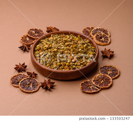Dried chamomile flowers, herbal tea in a bowl for a hot morning drink. Dried chamomile Dried chamomile flowers, herbal tea in a bowl for a hot morning drink. Dried chamomile 133503247