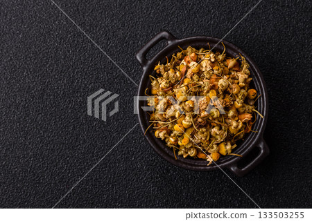 Dried chamomile flowers, herbal tea in a bowl for a hot morning drink. Dried chamomile Dried chamomile flowers, herbal tea in a bowl for a hot morning drink. Dried chamomile 133503255