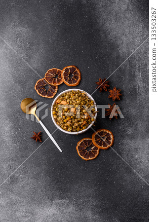 Dried chamomile flowers, herbal tea in a bowl for a hot morning drink. Dried chamomile Dried chamomile flowers, herbal tea in a bowl for a hot morning drink. Dried chamomile 133503267