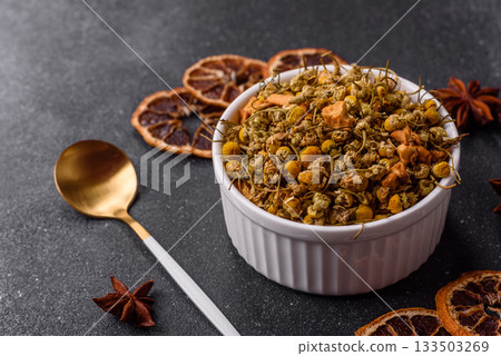 Dried chamomile flowers, herbal tea in a bowl for a hot morning drink. Dried chamomile 133503269