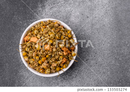 Dried chamomile flowers, herbal tea in a bowl for a hot morning drink. Dried chamomile Dried chamomile flowers, herbal tea in a bowl for a hot morning drink. Dried chamomile 133503274