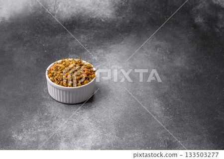 Dried chamomile flowers, herbal tea in a bowl for a hot morning drink. Dried chamomile 133503277