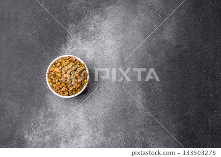 Dried chamomile flowers, herbal tea in a bowl for a hot morning drink. Dried chamomile Dried chamomile flowers, herbal tea in a bowl for a hot morning drink. Dried chamomile 133503278