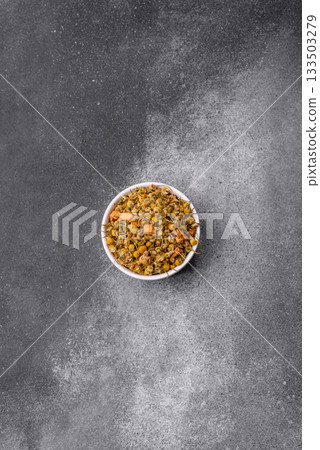 Dried chamomile flowers, herbal tea in a bowl for a hot morning drink. Dried chamomile 133503279