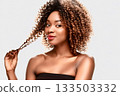 A woman showing off her curls 133503332