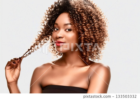 A woman showing off her curls A woman showing off her curls 133503332