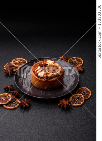 Cinnamon roll, a sweet bun with citrus, cherries, and chocolate, a Danish dessert with cream 133503336