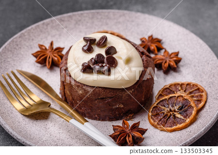 Cinnamon roll, a sweet bun with citrus, cherries, and chocolate, a Danish dessert with cream 133503345