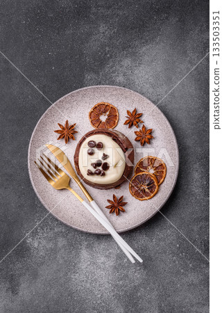 Cinnamon roll, a sweet bun with citrus, cherries, and chocolate, a Danish dessert with cream 133503351