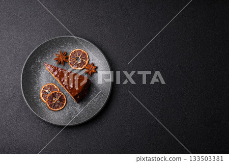 A slice of sweet layered cake covered in chocolate with nuts and caramel. A slice of chocolate cake A slice of sweet layered cake covered in chocolate with nuts and caramel. A slice of chocolate cake 133503381