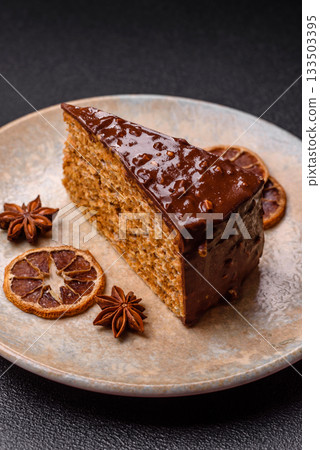 A slice of sweet layered cake covered in chocolate with nuts and caramel. A slice of chocolate cake A slice of sweet layered cake covered in chocolate with nuts and caramel. A slice of chocolate cake 133503395