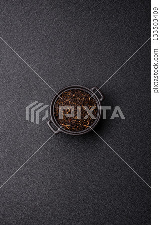 Golden black tea, dried leaves of a Chinese or Indian breakfast drink. Black tea dried leaves Golden black tea, dried leaves of a Chinese or Indian breakfast drink. Black tea dried leaves 133503409