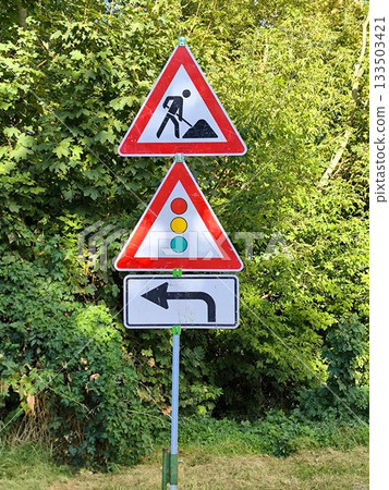 Road works: temporary traffic lights and detour sign 133503421