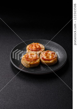 Round fish or chicken cutlets baked with tomato and cheese. Fish cutlets 133503506