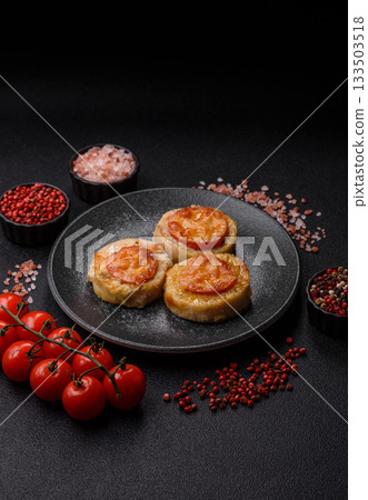 Round fish or chicken cutlets baked with tomato and cheese. Fish cutlets Round fish or chicken cutlets baked with tomato and cheese. Fish cutlets 133503518