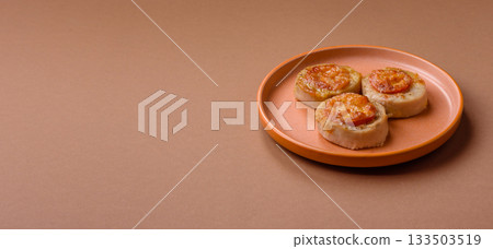 Round fish or chicken cutlets baked with tomato and cheese. Fish cutlets Round fish or chicken cutlets baked with tomato and cheese. Fish cutlets 133503519
