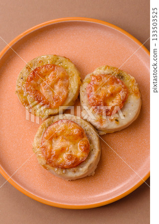 Round fish or chicken cutlets baked with tomato and cheese. Fish cutlets Round fish or chicken cutlets baked with tomato and cheese. Fish cutlets 133503525
