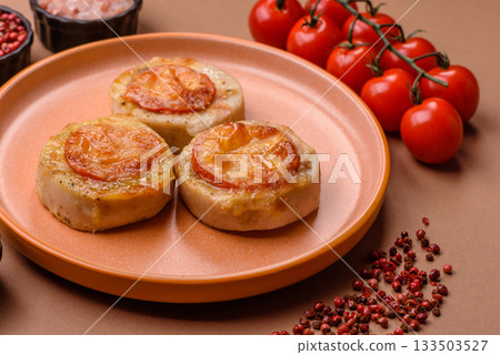Round fish or chicken cutlets baked with tomato and cheese. Fish cutlets 133503527
