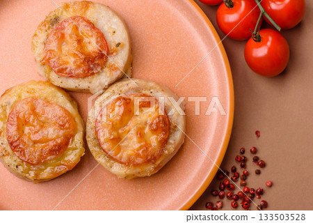 Round fish or chicken cutlets baked with tomato and cheese. Fish cutlets Round fish or chicken cutlets baked with tomato and cheese. Fish cutlets 133503528