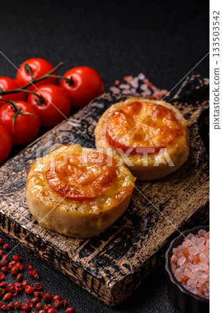 Round fish or chicken cutlets baked with tomato and cheese. Fish cutlets 133503542