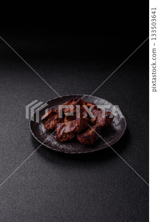Beef, grilled meat in pieces, or kebab with sauce and vegetables. Beef in pieces Beef, grilled meat in pieces, or kebab with sauce and vegetables. Beef in pieces 133503641