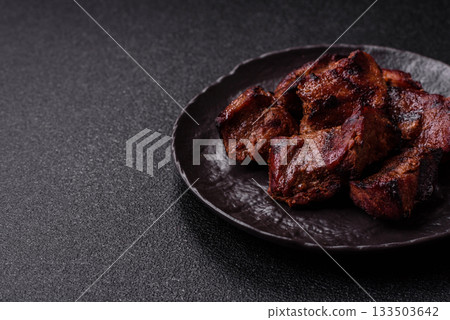 Beef, grilled meat in pieces, or kebab with sauce and vegetables. Beef in pieces Beef, grilled meat in pieces, or kebab with sauce and vegetables. Beef in pieces 133503642