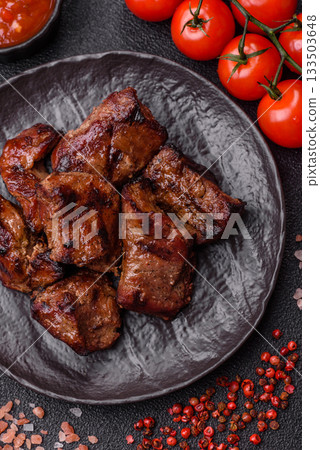 Beef, grilled meat in pieces, or kebab with sauce and vegetables. Beef in pieces 133503648