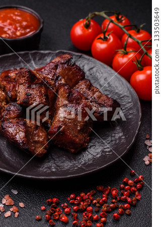 Beef, grilled meat in pieces, or kebab with sauce and vegetables. Beef in pieces 133503649