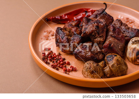 Beef, grilled meat in pieces, or kebab with sauce and vegetables. Beef in pieces Beef, grilled meat in pieces, or kebab with sauce and vegetables. Beef in pieces 133503658