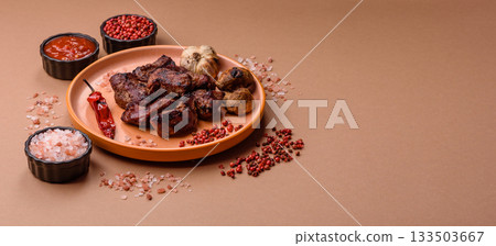 Beef, grilled meat in pieces, or kebab with sauce and vegetables. Beef in pieces 133503667
