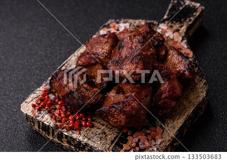 Beef, grilled meat in pieces, or kebab with sauce and vegetables. Beef in pieces Beef, grilled meat in pieces, or kebab with sauce and vegetables. Beef in pieces 133503683