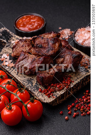Beef, grilled meat in pieces, or kebab with sauce and vegetables. Beef in pieces Beef, grilled meat in pieces, or kebab with sauce and vegetables. Beef in pieces 133503697