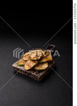 Grilled green zucchini slices, vegetarian food. Green barbecue zucchini Grilled green zucchini slices, vegetarian food. Green barbecue zucchini 133503754