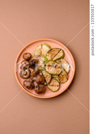 Grilled green zucchini slices, vegetarian food. Green barbecue zucchini Grilled green zucchini slices, vegetarian food. Green barbecue zucchini 133503817