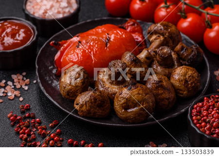 Grilled mushroom pieces, a vegetarian healthy meal with sauce. Barbecue mushroom halves Grilled mushroom pieces, a vegetarian healthy meal with sauce. Barbecue mushroom halves 133503839