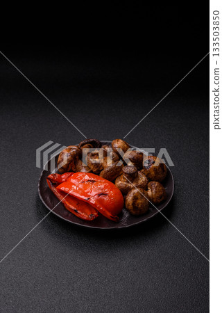 Grilled mushroom pieces, a vegetarian healthy meal with sauce. Barbecue mushroom halves Grilled mushroom pieces, a vegetarian healthy meal with sauce. Barbecue mushroom halves 133503850
